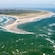 A landmass with a peninsula stretching out into a choppy body of water